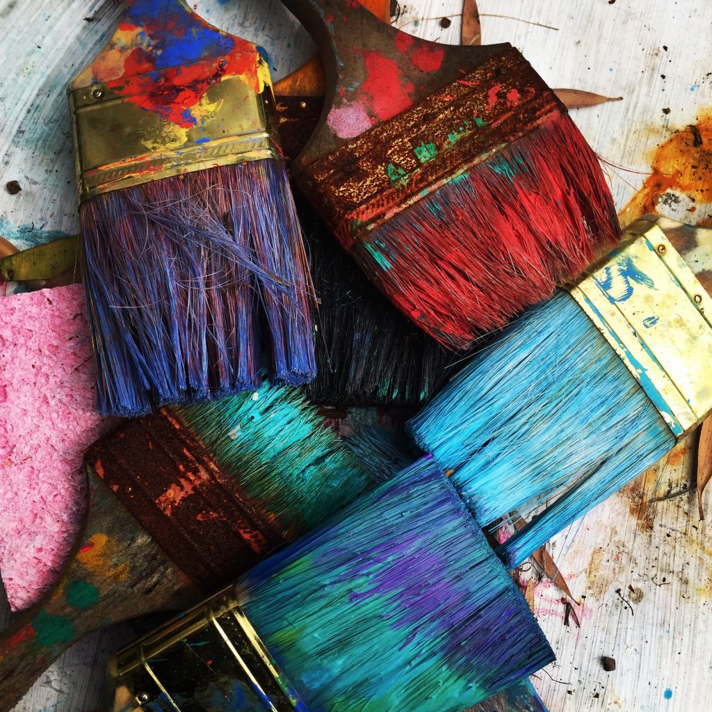 colourful used paint brushes